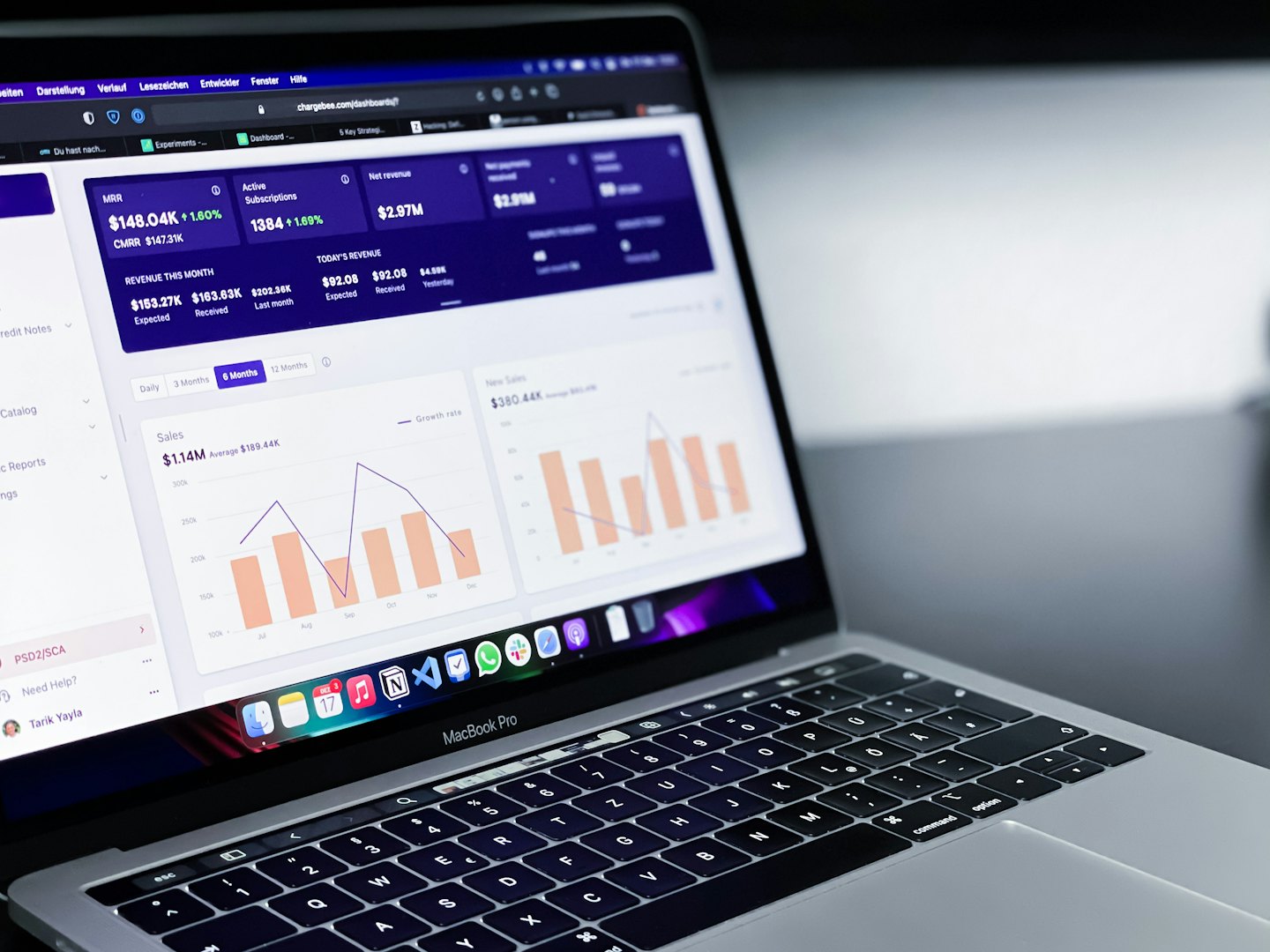 Silver laptop displays business analytics dashboard on a desk.